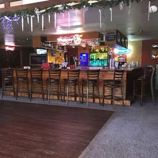 a bar with wooden tables and stools