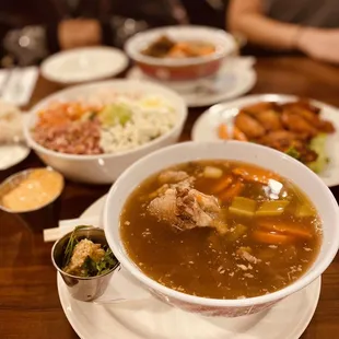 a bowl of soup with meat and vegetables