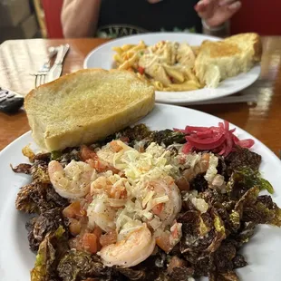 a plate of food and a woman sitting at a table