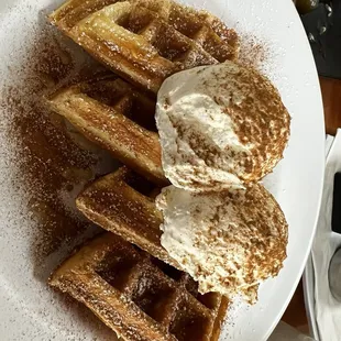 Waffles with honey and fresh cream and cinnamon