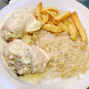 a plate of food with rice, meatballs, and french fries