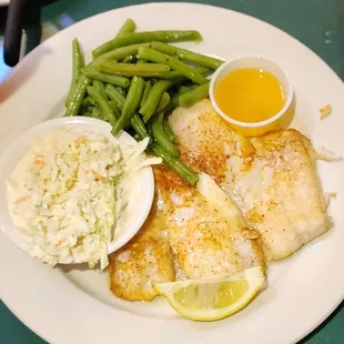 a plate of fish, green beans, and coleslaw