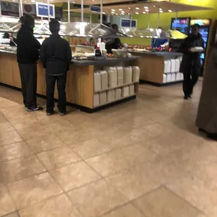 two people standing at a counter