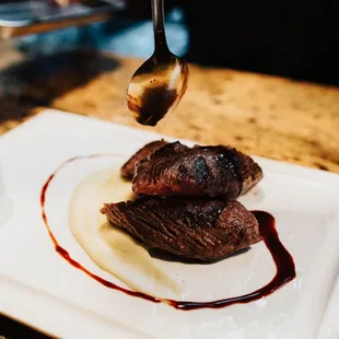 a plate of food and a spoon