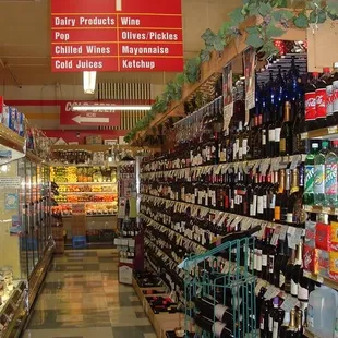 a wide aisle of wine bottles