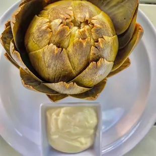 an artichoke on a white plate