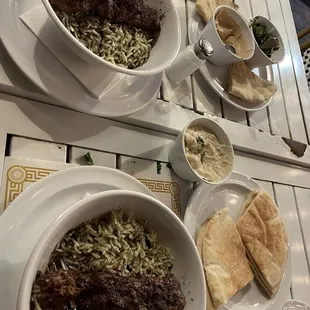 Koobideh kebab with herb rice pita with baba ghanouj hummus and tabouli and some red wine