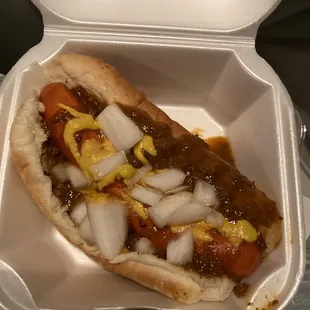 a hot dog in a styrofoam container
