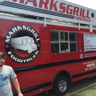 a man standing in front of a food truck