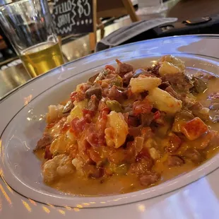 a plate of pasta with meat and vegetables