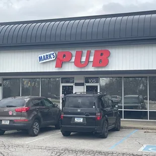 two cars parked in front of the pub