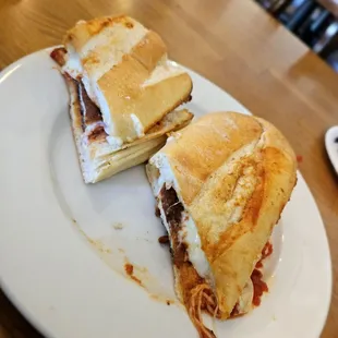 The chicken Parm sandwich, unevenly cut.