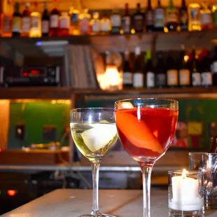 two glasses of wine on a bar