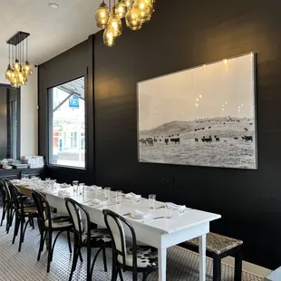 a dining room with a long table and chairs