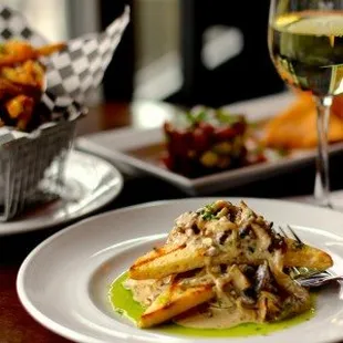 a plate of food and a glass of wine