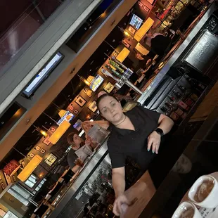 a woman standing in front of a bar