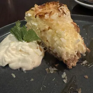 Partially eaten and exceptional coconut cheesecake.