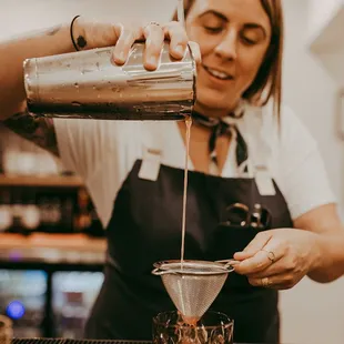 a bartender pouring a drink