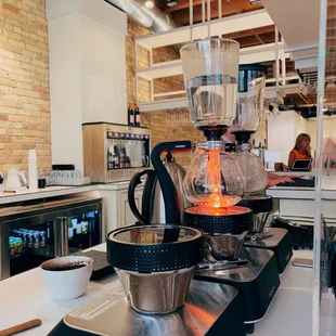 a kitchen counter with a blender, coffee maker, and coffee pot