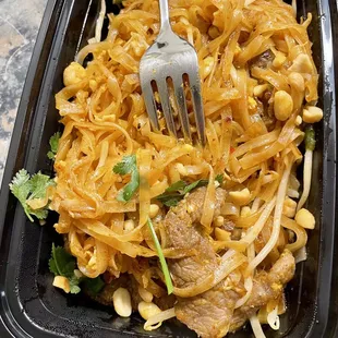 a fork in a bowl of noodles