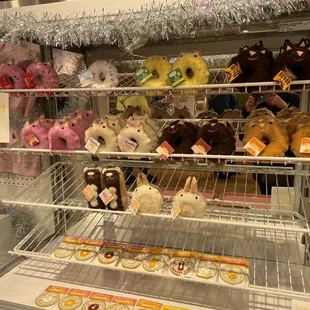 Donut animal plushies displayed on faux donut display racks. Cute.