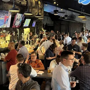 a large group of people sitting at a bar