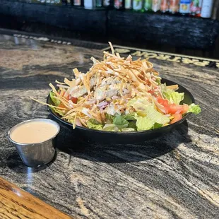 a plate of salad with dressing