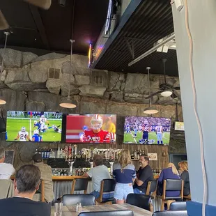a group of people watching tvs