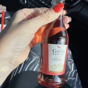 a woman holding a bottle of maroa