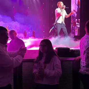 a man singing on stage