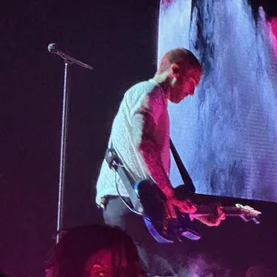 a man playing a guitar on stage