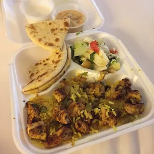 Chicken Shawarma platter with Greek salad, cucumber dressing and a side of pita with hummus.