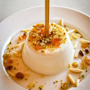 Mahalabieh - Middle Eastern pudding topped with pistachios, raisins, almonds and pistachios with rose water.