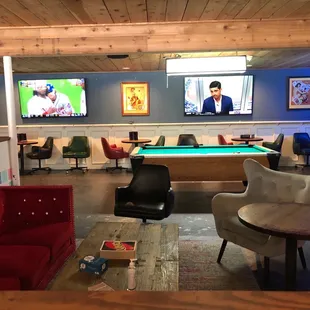 Nice living room like area, pool table, TVs.