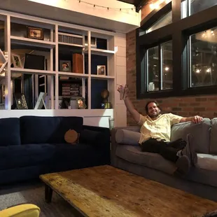 a man sitting on a couch in a living room