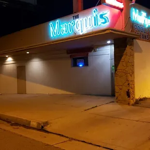 Beautifully lit up MARQUIS neon  w/ the classic "cocktail" neon making sure those who drive by know this aint no beer bar