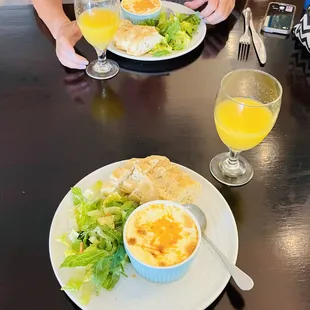 a plate of food and a glass of orange juice