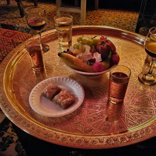 Fresh fruits, hot mint tea, and baklava