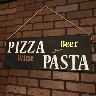 a sign on a brick wall