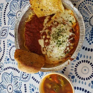 a bowl of spaghetti and bread