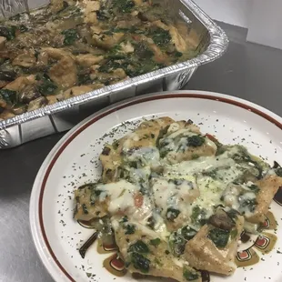 a plate of food and a pan of lasagna