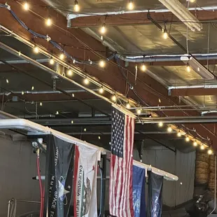 the interior of a brewery with american flags hanging from the ceiling