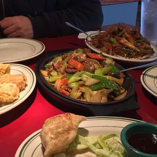 Szechuan beef, Mongolian Beef, egg rolls, and the remaining giant potsticker.