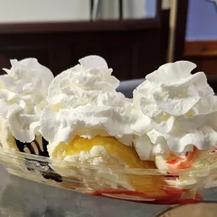 a banana split with whipped cream and strawberries