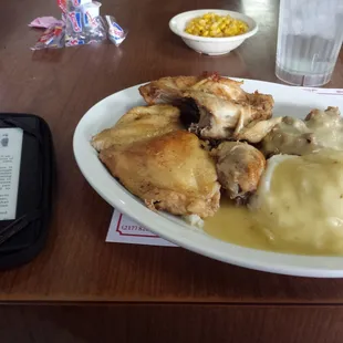 Roast chicken dinner with mashed,  dressing, and gravy.