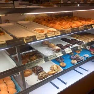a variety of donuts in a display case