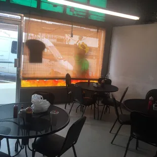 tables and chairs in front of a window