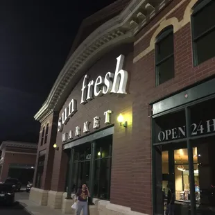 a woman standing in front of the store