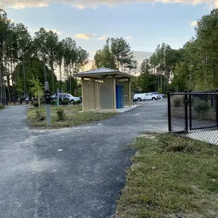 Portable toilet located near the dog parks and the parking lot by the dog parks