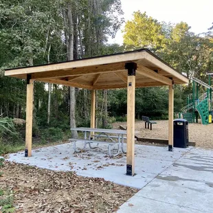 Pavilion covered picnic table and trash can